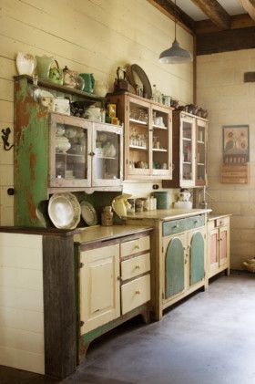 A collection of vintage dressers in the kitchen.Photographer: Craig Wall