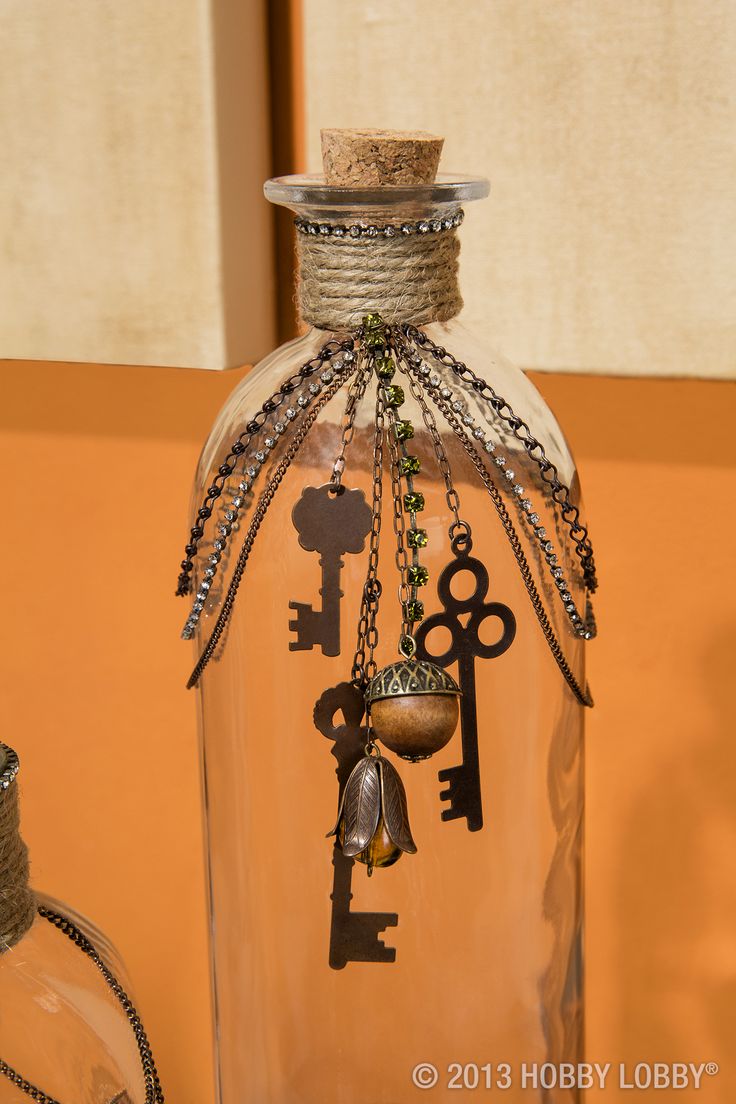 Upcycle glass bottles with twine and jewelry accents for an easy-to-create maste...
