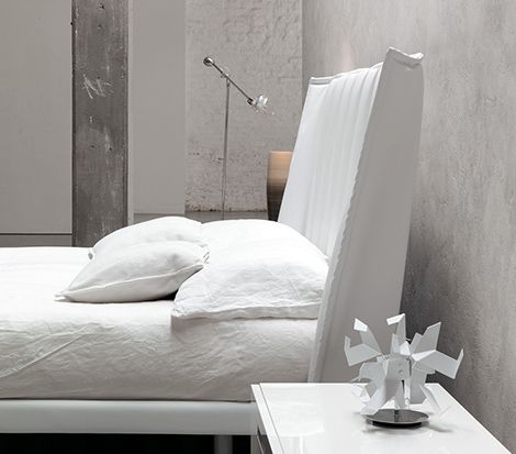 White on white.  I love the exposed concrete and that head board is amazing!