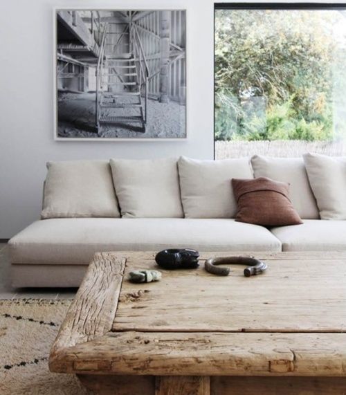 Beni Ourain carpet with a  linen couch & a rustic coffee table