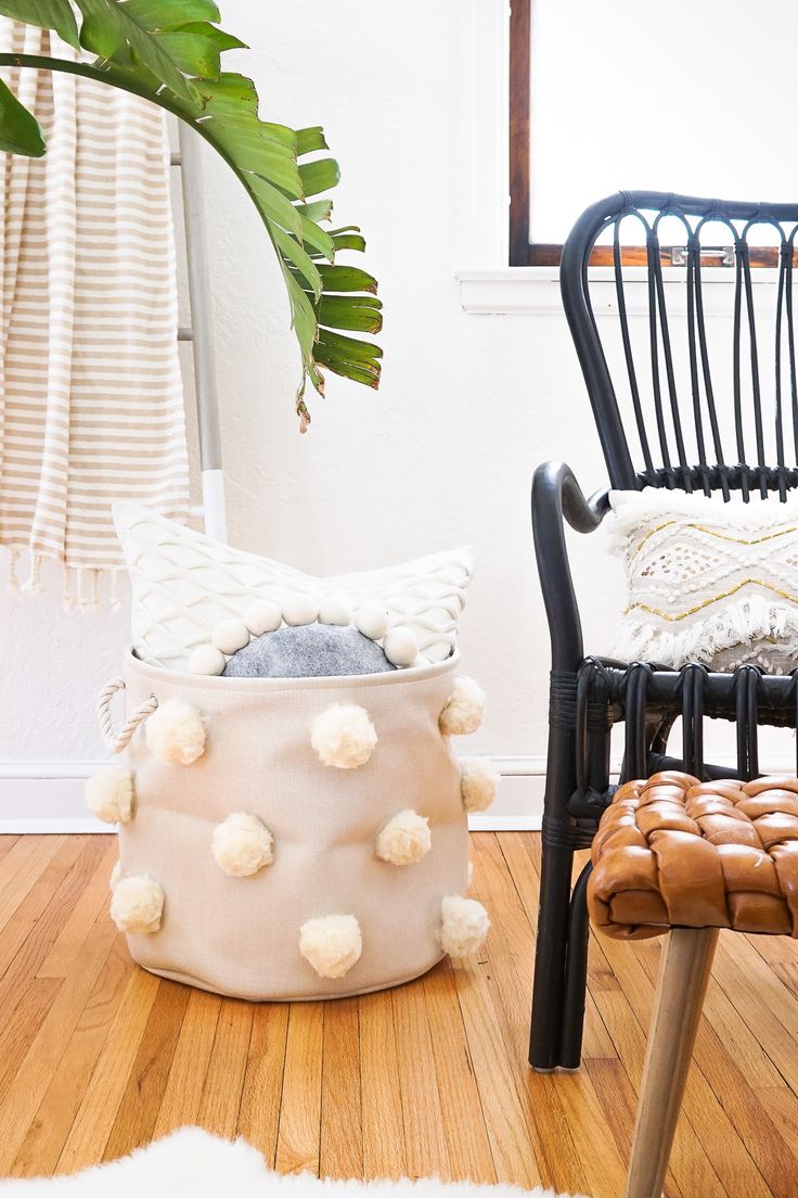 Love neutrals? This DIY fluffy pom pom bin provides a nice bit of texture while ...