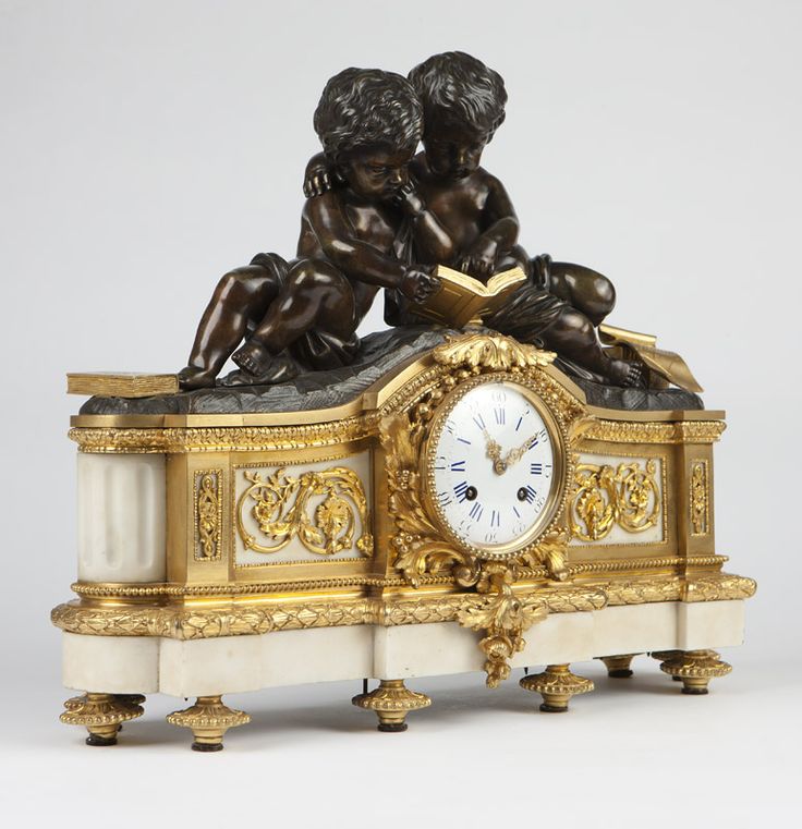 A French patinated & gilt-bronze figural clock. Late 19th century, the twin-trai...