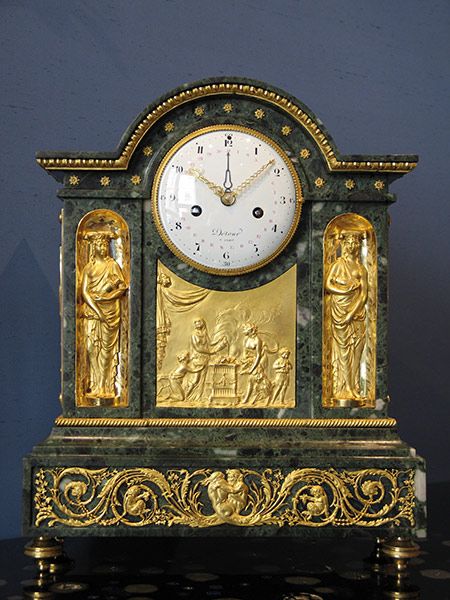 A late Louis XVI gilt bronze mounted verde antico marble mantel clock.