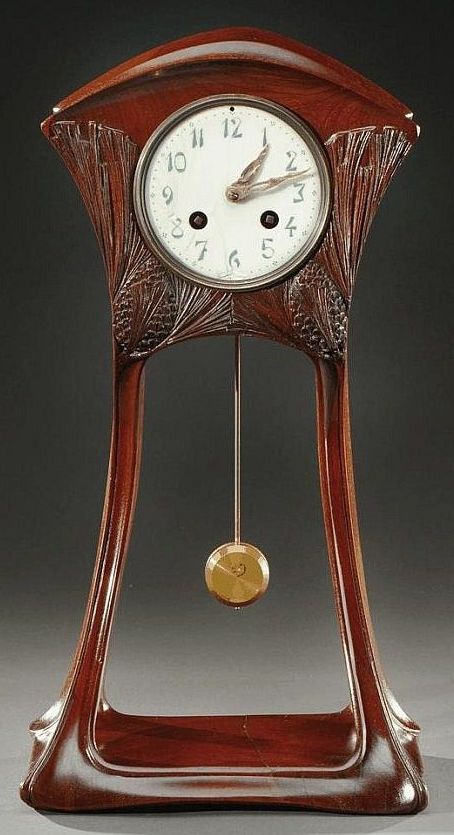 MAURICE DUFRENE: Mahogany mantel clock, showing characteristic Art Nouveau aesth...