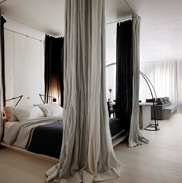Fake four poster bed using curtain rods and curtains.