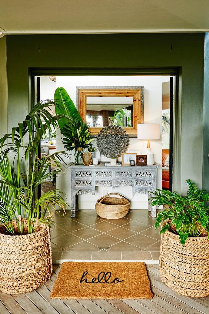 Amazing global style entryway filled with plants