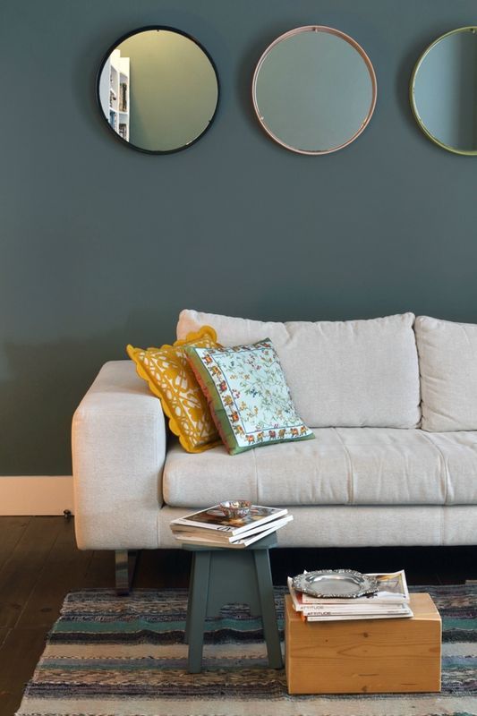 mur bleu gris mettant en valeur le canapé couleur lin et contrasté par les tou...