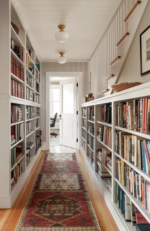 Built-in books shelves in hallway with runner