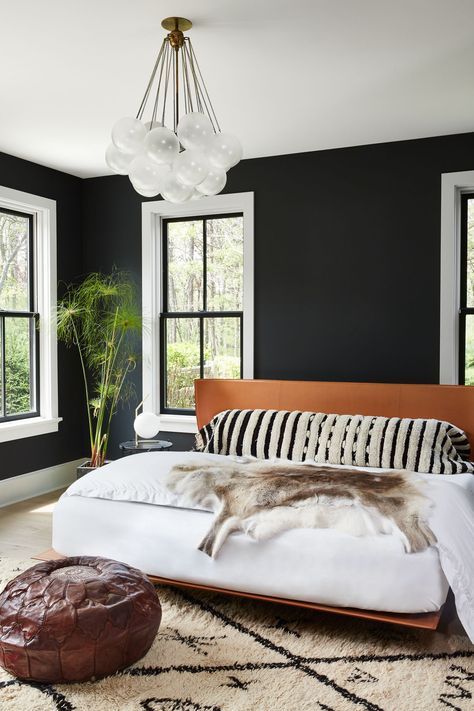 Love that light fitting, the black walls, the headboard, the hide. Delish!