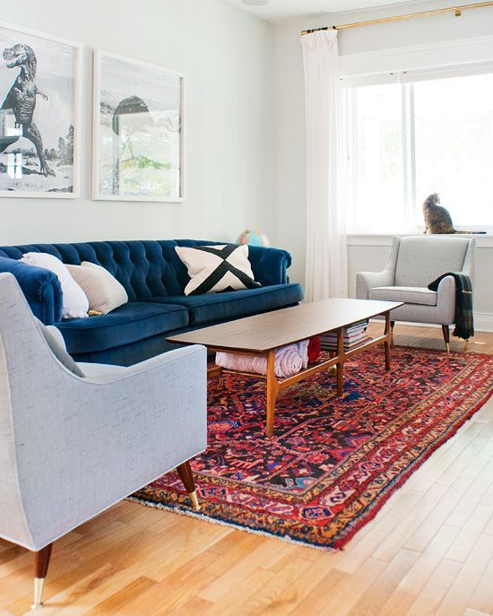 Persian rug, tufted blue velvet sofa, mid-century chairs in Sunbrella fabric, ne...