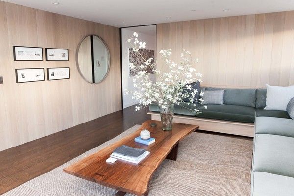 The penthouse living room and bar by Catherine Kwong features a Nakashima Cockta...