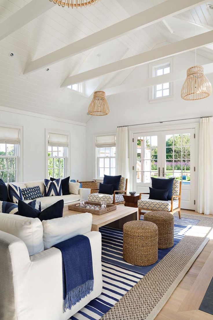 coastal white and blue living room with layered rugs