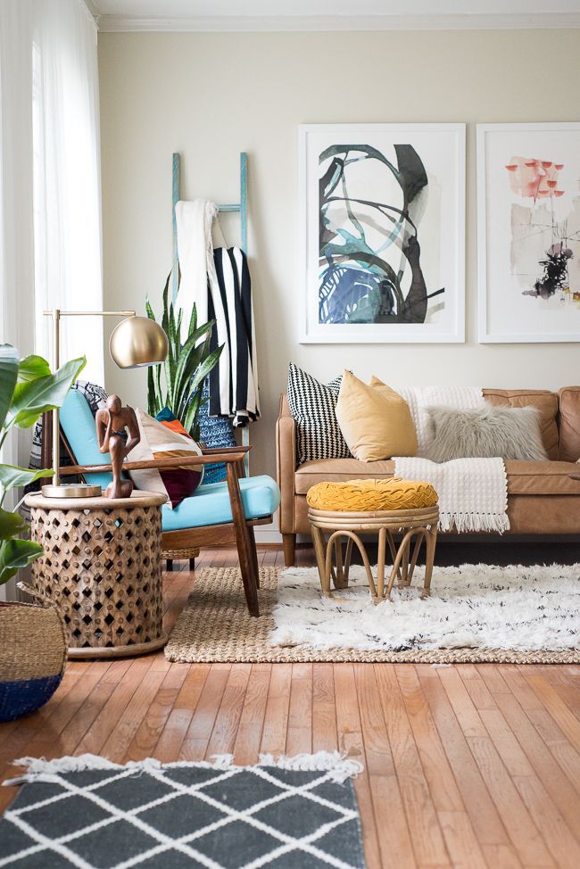 layered rugs in living room add to the boho feeling of the space