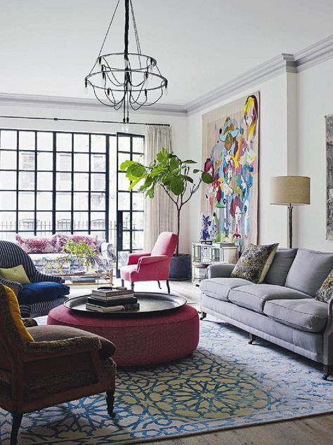 living room with colorful details in bright pink and graphic rug