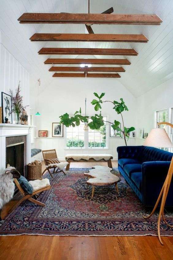loving the blue sofa, the white vaulted ceiling and the wood beams