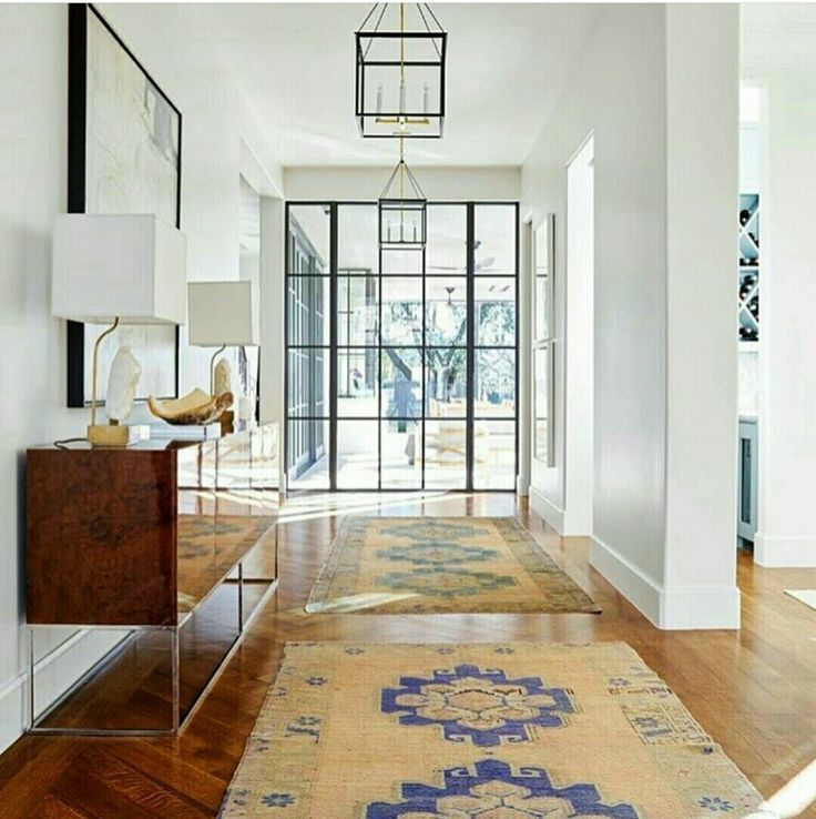 stunning entryway with wood floor, accent colors in yellow ugs