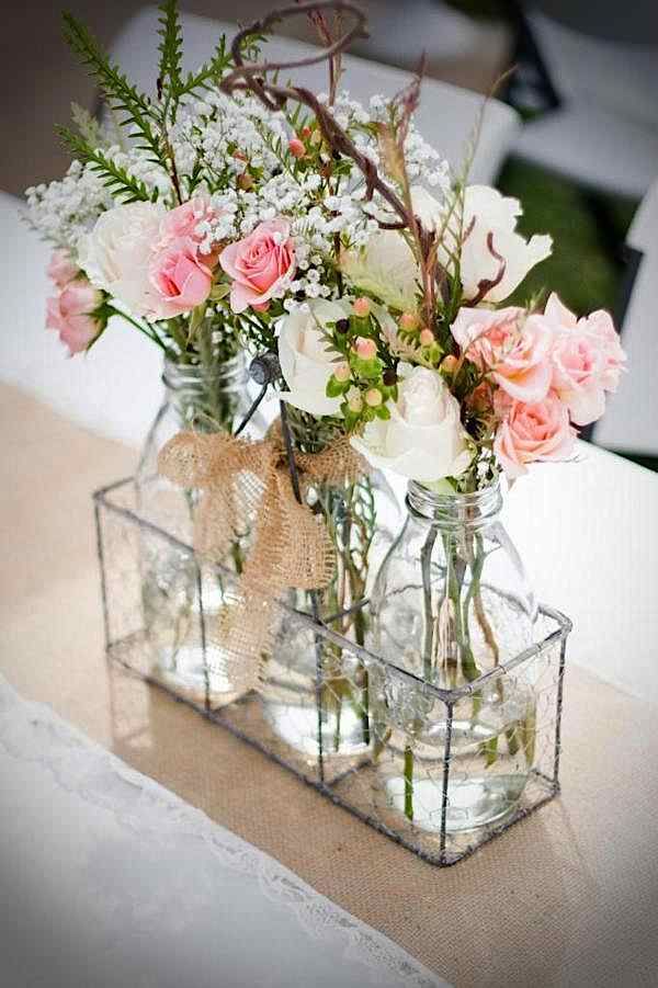 Simple florals in glass bottles for an inexpensive rustic centerpiece #centerpie...