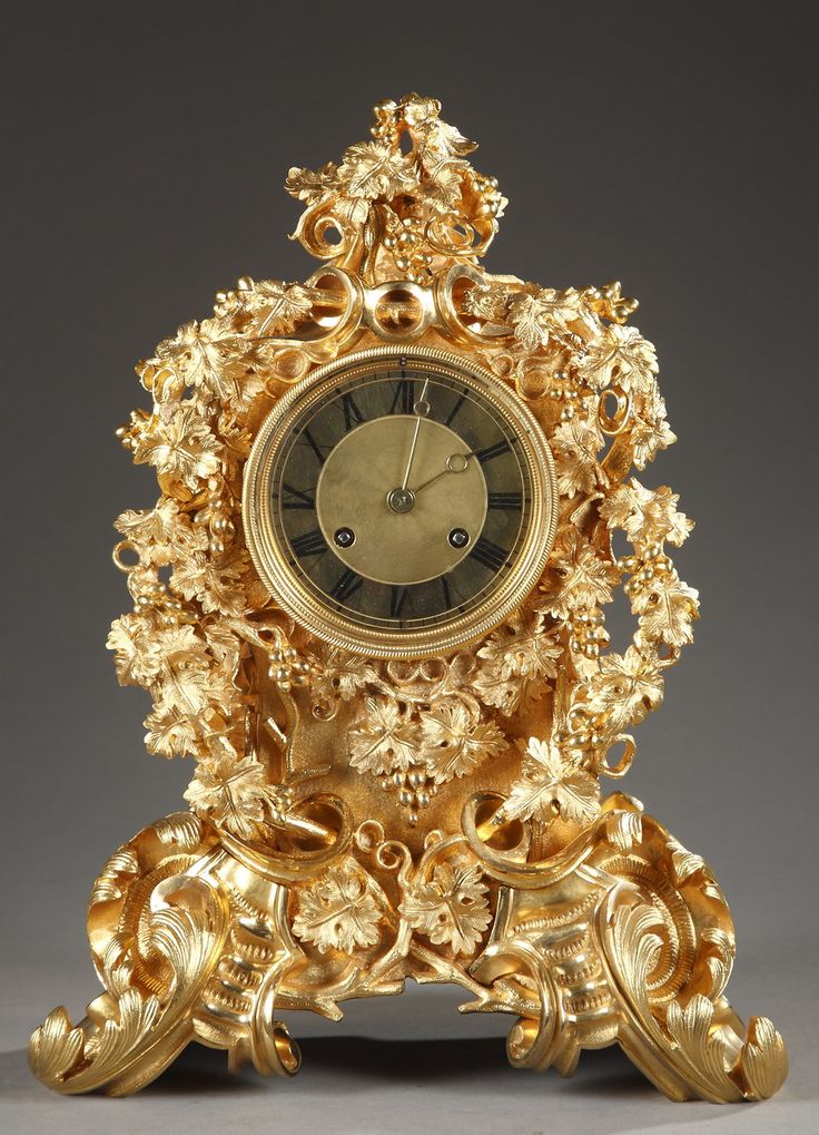 Mid 19th century French Rococo style clock decorated with vines surrounding the ...
