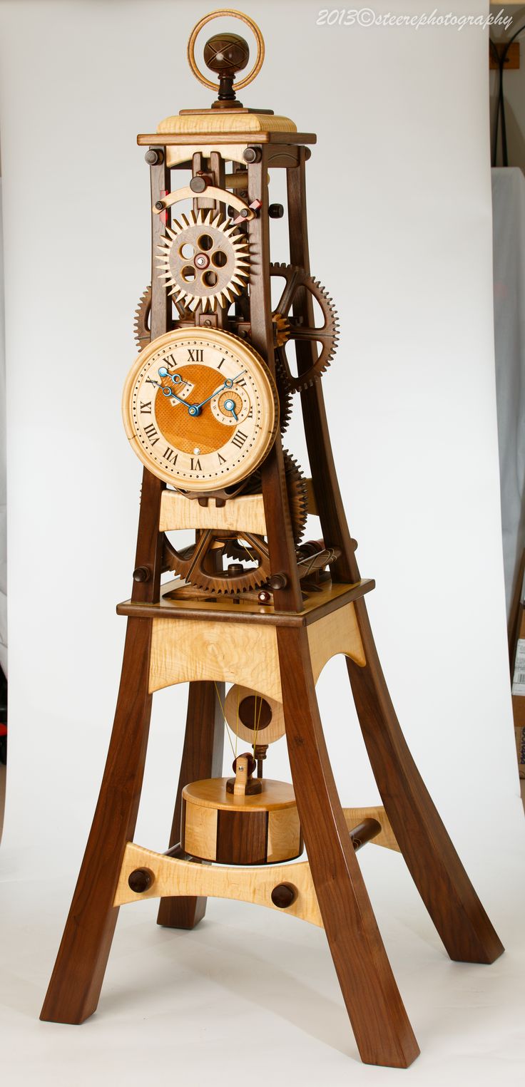 This is a wooden clock designed and built by Charles Maxwell, owner of Hardwoodc...