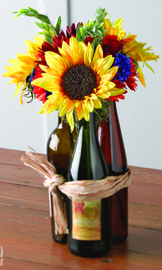 Wine bottle centerpiece. I LOVE this!!! Possibly add a few whiskey bottles....