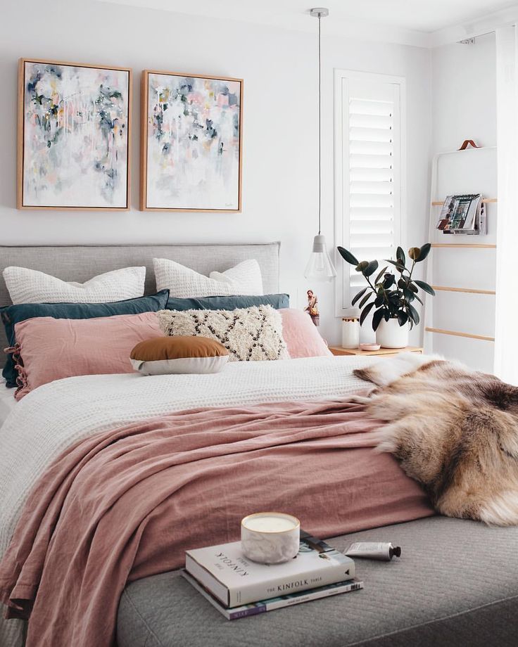 A chic modern bedroom with a white, gray, and blush pink color scheme. The faux ...
