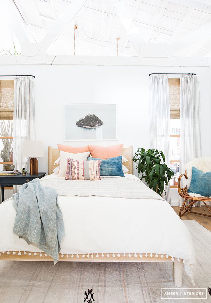 Bright white bedroom with exposed ceiling beams and bohemian décor