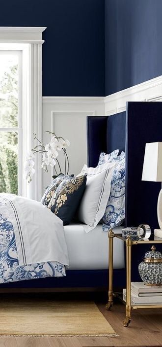 Navy Blue Bedroom.  Love the blue headboard and floral bedding.