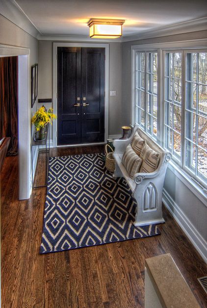 A dark rug is an excellent idea for a high-traffic area. The old church pew has ...