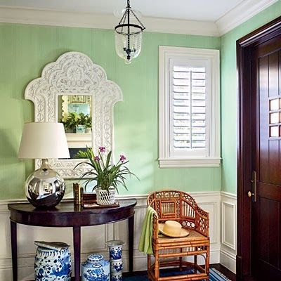 Beautiful entryway.  Ginger jars and the white mirror shine in this tropical ent...
