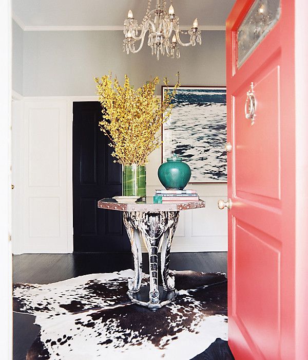 Bright coral door + graphic cowhide rug = a combo we adore.