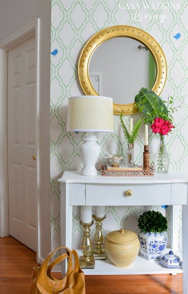 Green stenciled wall shines in this tropical entryway