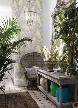 Tropical entryway with worn wooden console table and plants