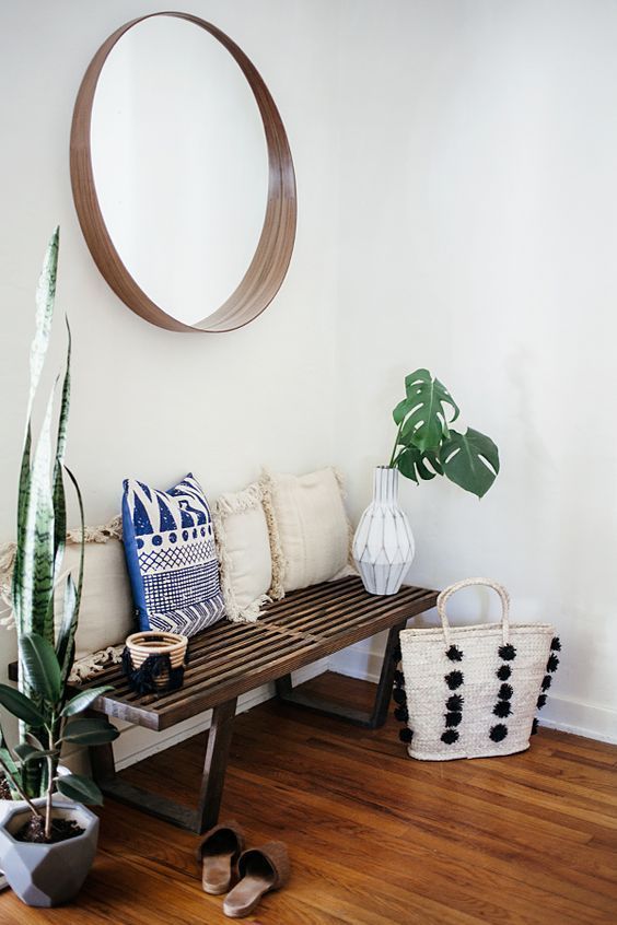 White Entryway with bench and plants