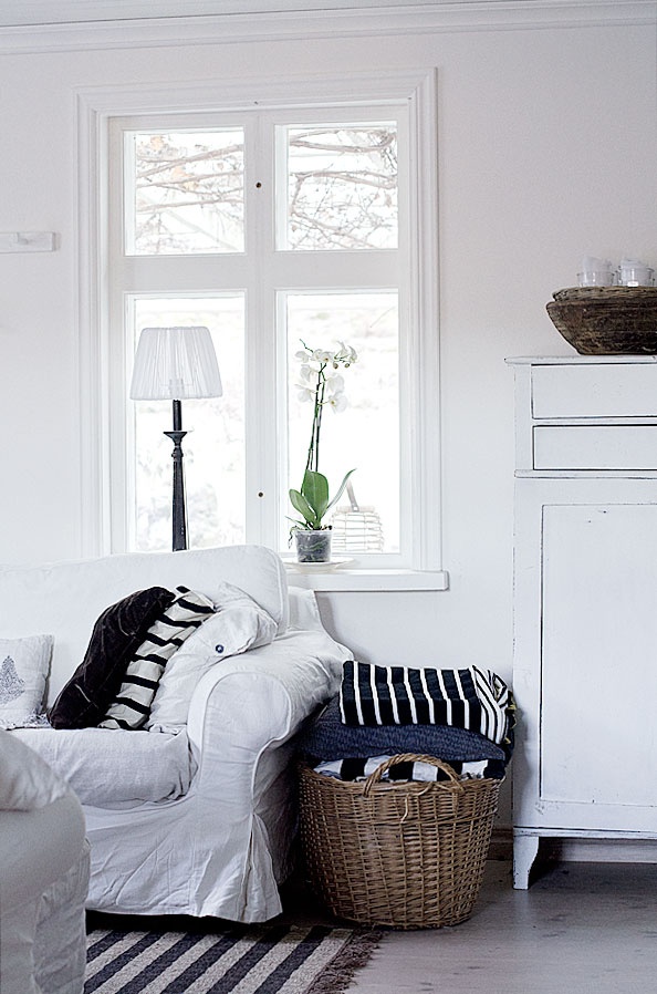STAGING :: I love the use of baskets filled w/ blankets & throws next to couches...