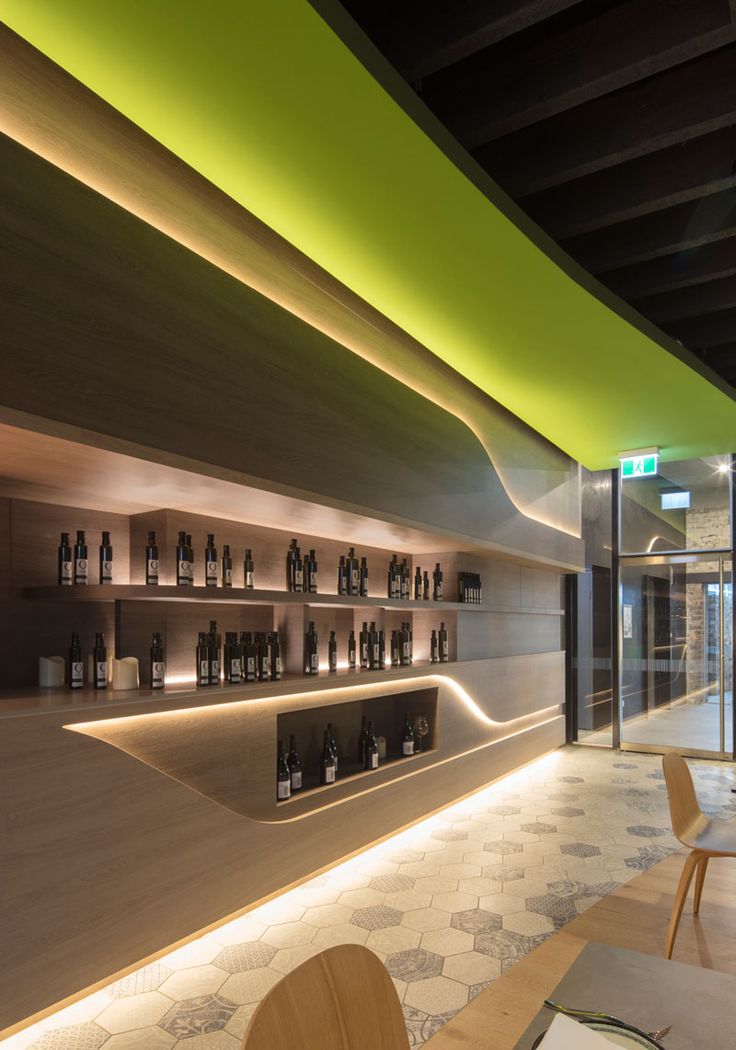 Interior Lighting Design Ideas – A wall of hidden LED lights behind wood panels creates a warm modern glow