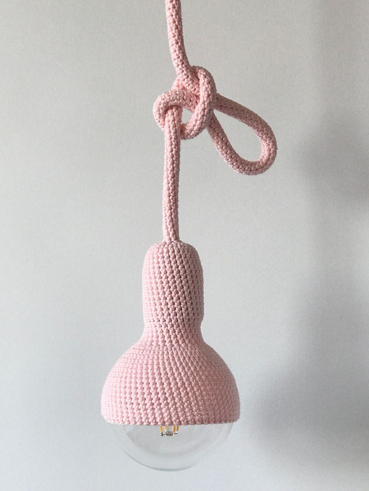 The blush pink crocheted exterior of this pendant lamp gives it an interesting t...