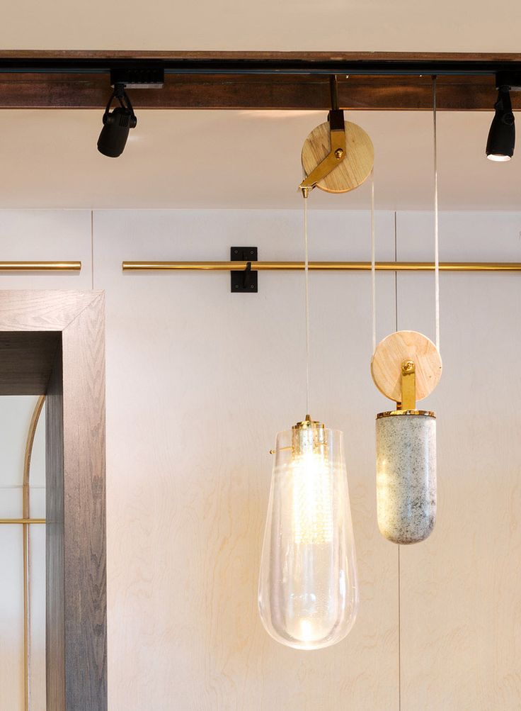 These custom-designed pendant lights that are on a pulley system, consist of a d...