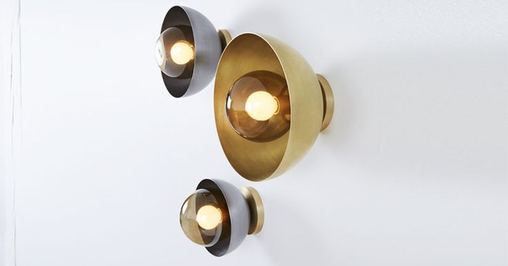 These modern metallic wall sconces are made from hand blown glass, with a steel ...