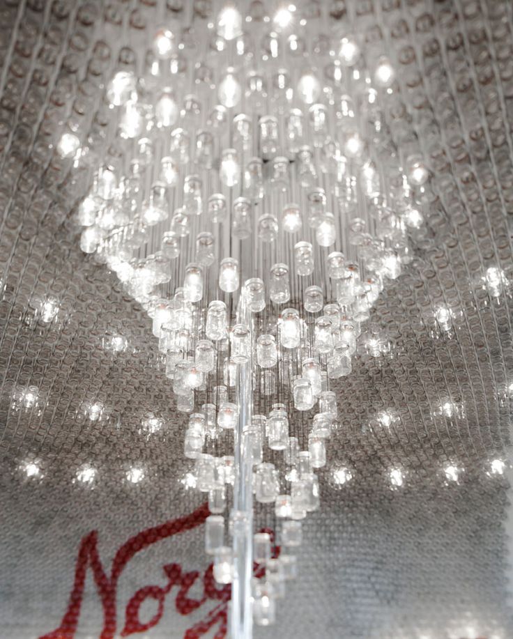 This large, modern and delicate chandelier in an airport bar in Oslo, is made fr...