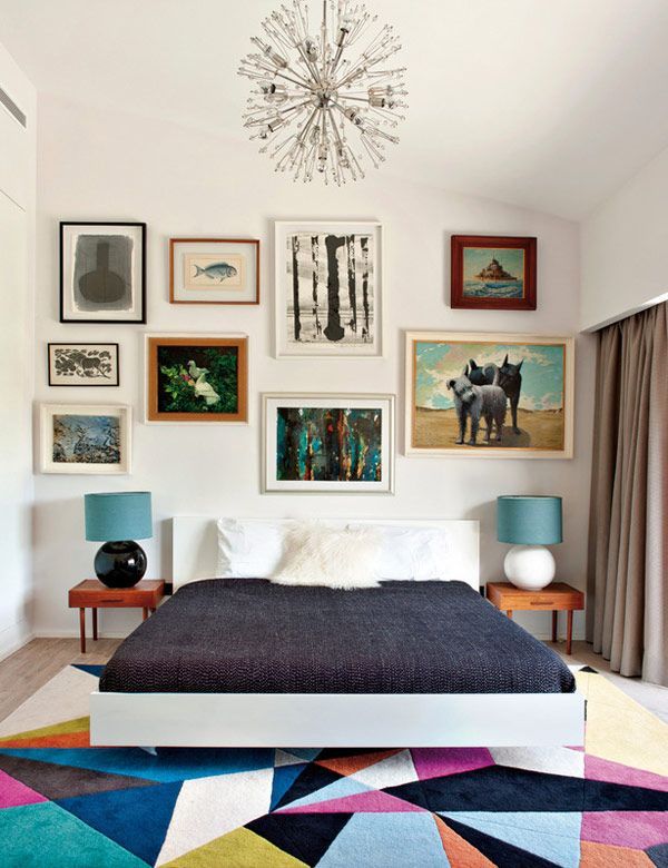 Love the colorful geometric rug, raw linen bed sheets, bedside tables, wall of f...