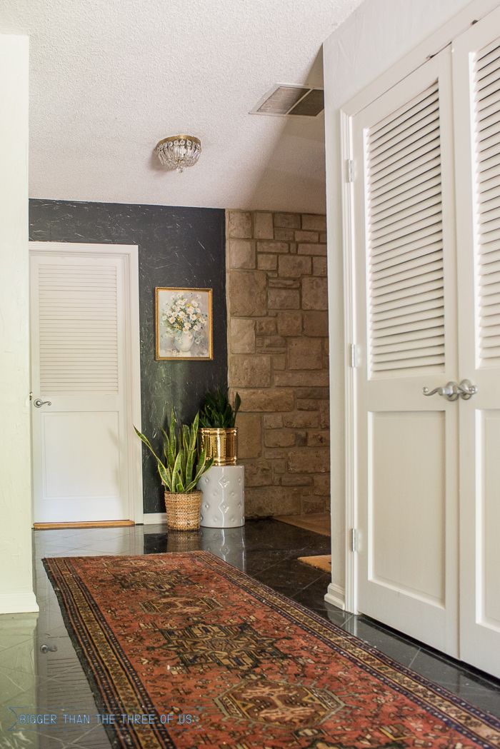 Vintage Persian Rug in Entryway with Dark accent wall and plants