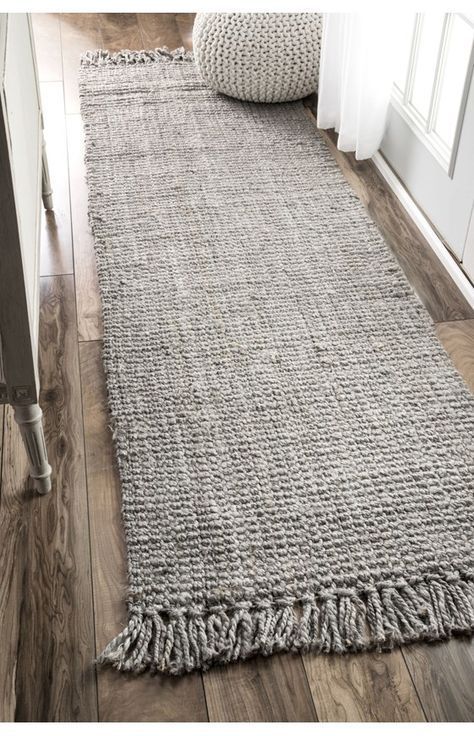grey rug with tasseled edges