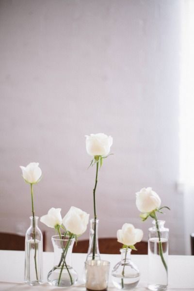 Pretty white flowers in small vases: www.stylemepretty... | Photography: Taylor ...