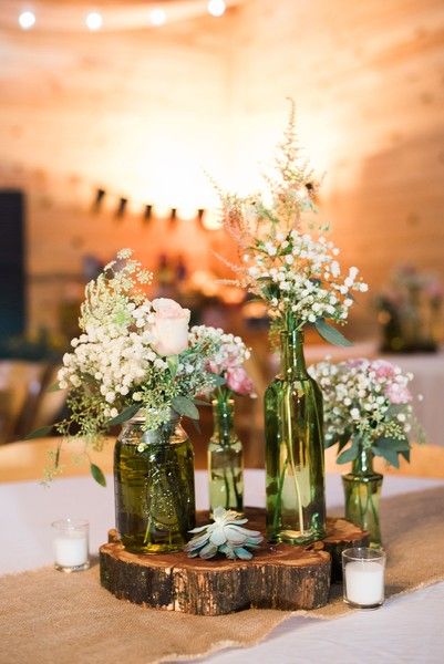 Rustic wedding centerpiece idea - vintage bottles with pink and white flower arr...
