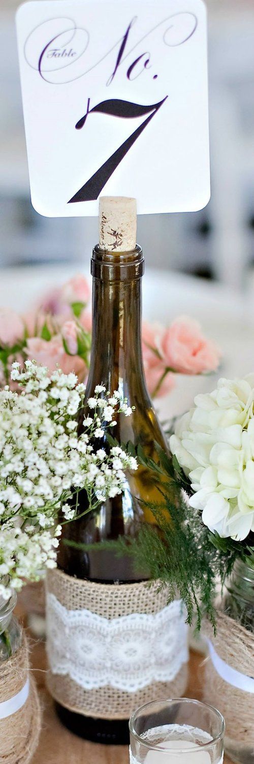 Wie bottles wrapped with burlap and lace.  Used to display table numbers at a we...