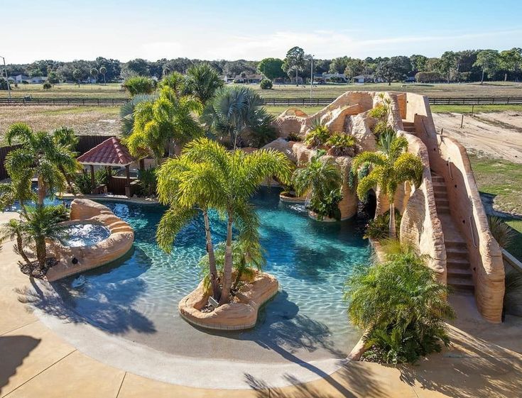 Resort-style pool with beach entry, waterfalls, a swim-up tiki bar, 70-foot wate...