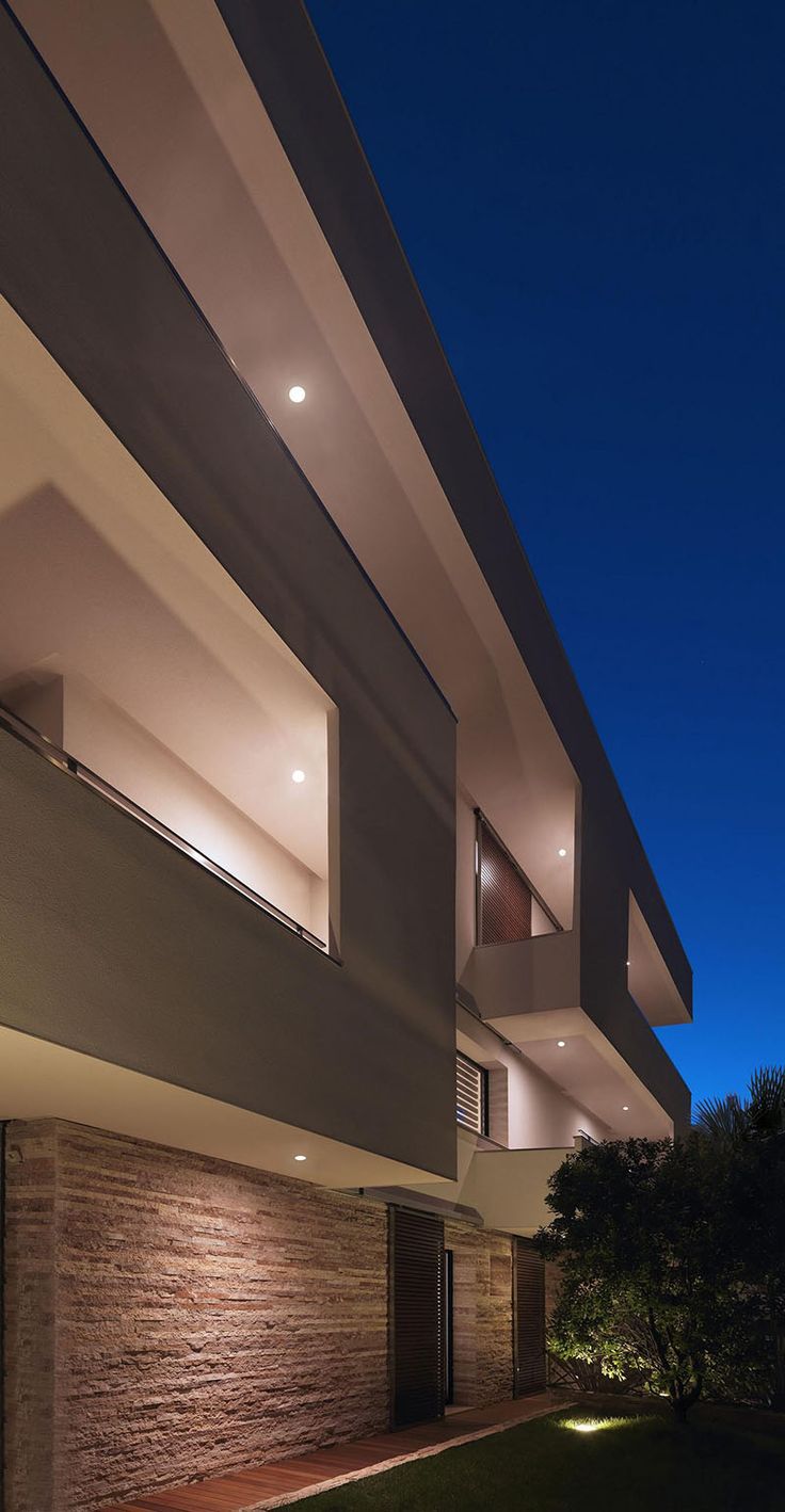 Lighting was added to this home to show off the balconies, making the building f...