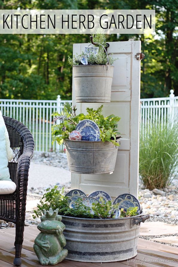 Make a vertical kitchen herb garden from an old door and galvanized metal bucket...