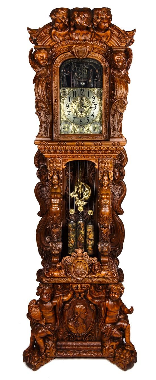 A Monumental English Carved Oak Tall Case Clock