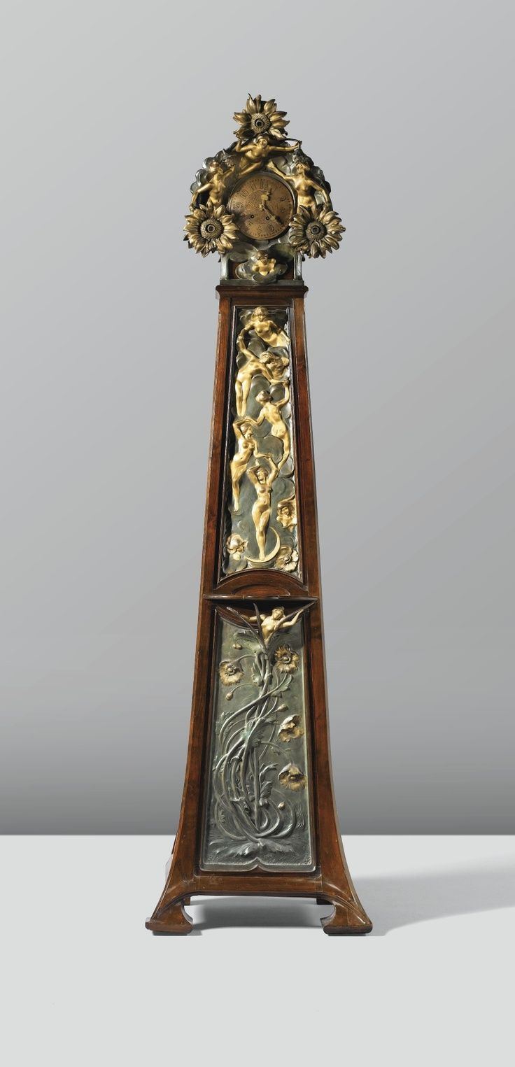 A STAINED WALNUT AND METAL LONG-CASE CLOCK BY FERDINAND DE SAINTILAN, THE MOUNTS...